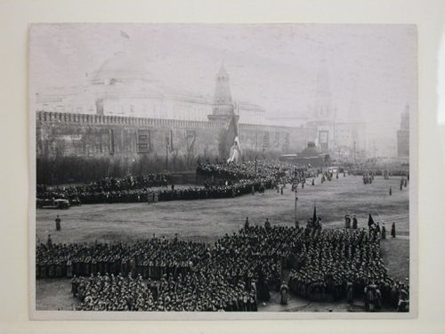 View of a parade in Red Square with the second wooden Lenin Mausoleum and the Nikol'skaya Tower (Nicholas Tower) in the background, Moscow