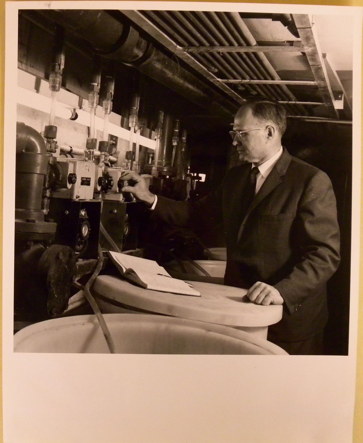 View of Lucien Rodrigue controlling the chemical system at the Alcan Dolphin Pool, Expo 67, Montréal, Québec