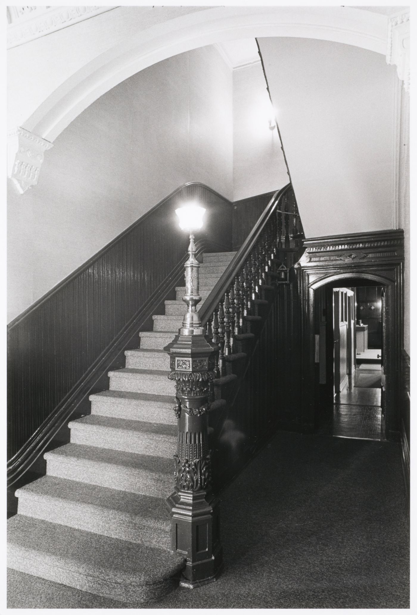 Interior view of the original carved wooden stairs in the east part of Shaughnessy House, Montréal, Québec