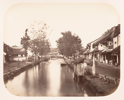 View of buildings, the Krukut River and Jalan Toko Tiga street in Glodok, Batavia (now Jakarta), Dutch East Indies (now Indonesia)