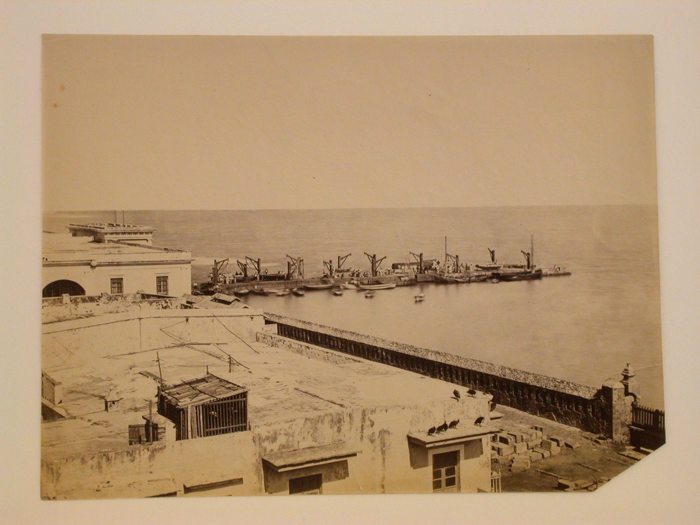 View of buildings and a pier with boats and people with the Gulf of Mexico in the background, Veracruz, Mexico