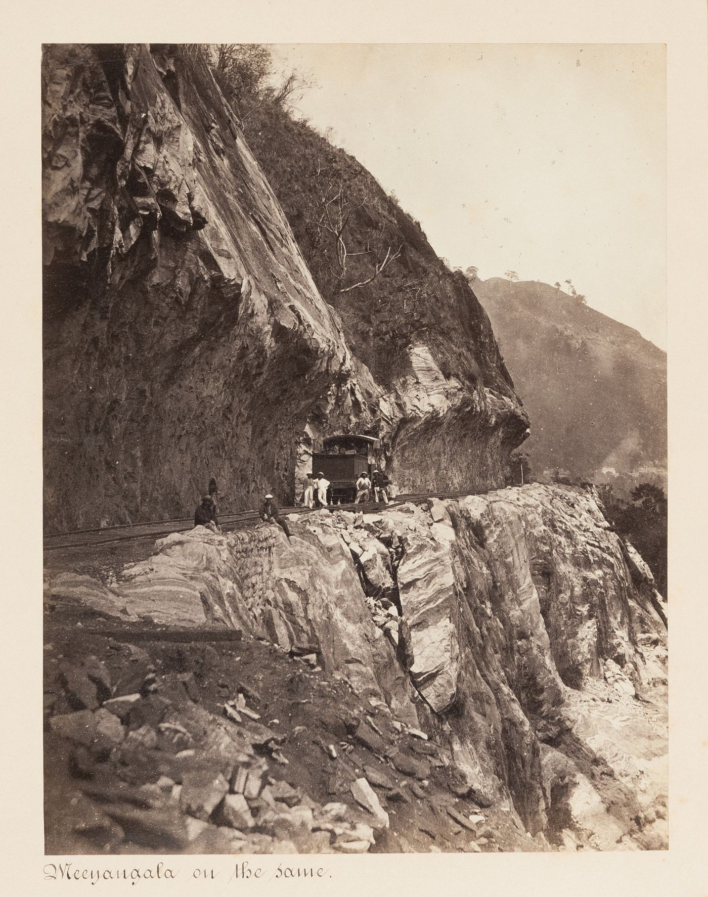 View of a locomotive and men on the Colombo-Kandy Railway, Ceylon (now Sri Lanka)