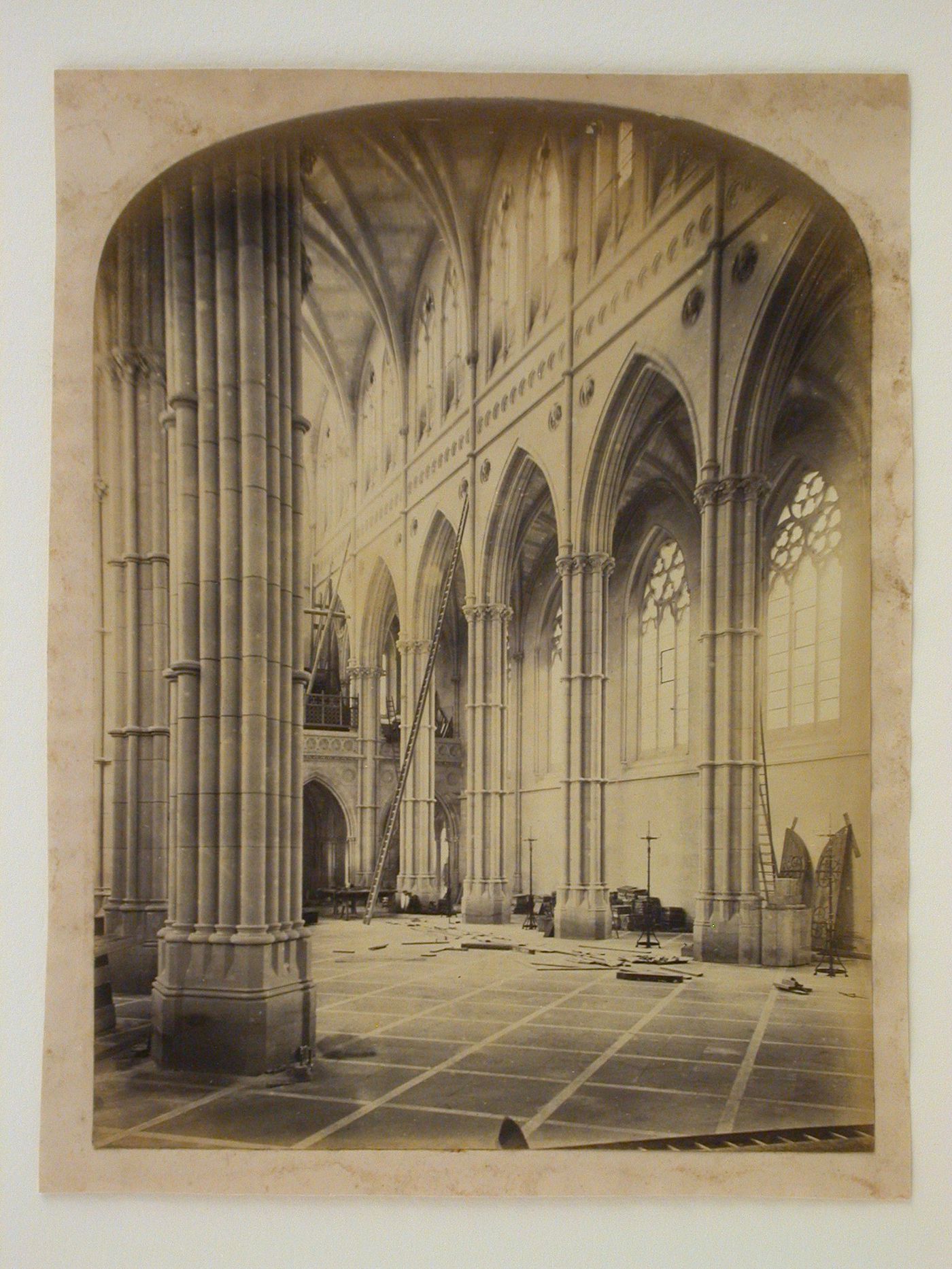 Interior partial view of the Church of St. Philip Neri (now the Cathedral of Our Lady and St. Philip Howard) under construction showing the nave and the north aisle, Arundel, West Sussex, England