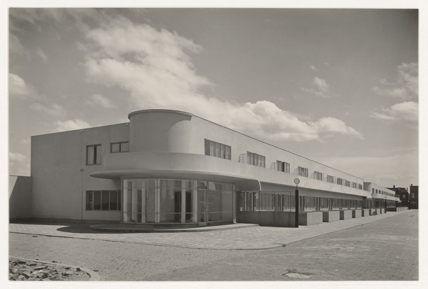 View of the principal façade of industrial row houses showing a corner store, Hoek van Holland, Netherlands
