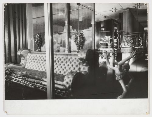 Interior view of Casa Devalle showing a mirrored room with a silver satin divan, a glass wall with gilded columns through which a photographic enlargement of clouds and sky can be seen, and a tempered glass table modelled by Italo Cremona, Turin, Italy
