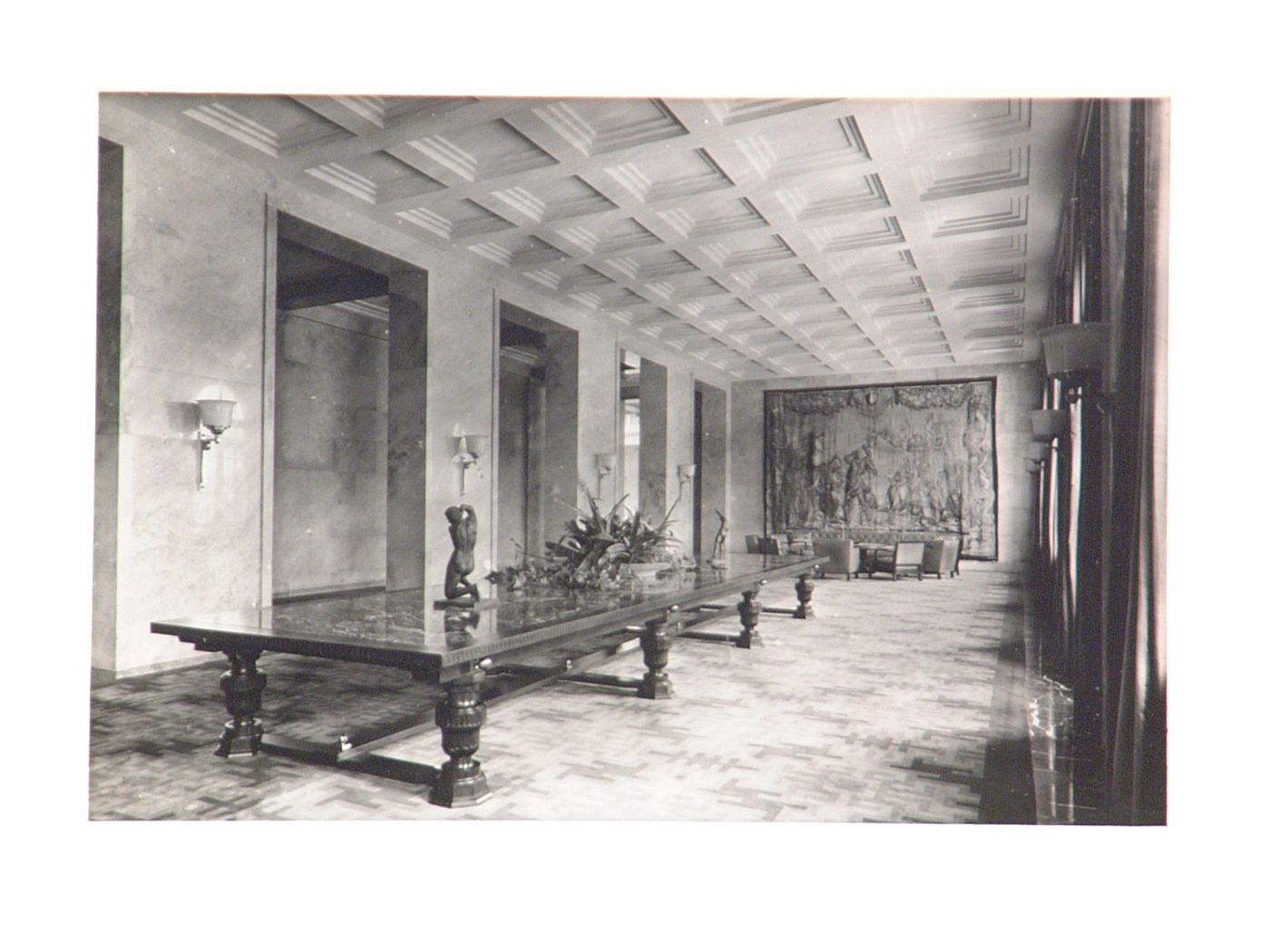 Interior, view of long room with long table, tapestry on wall at end