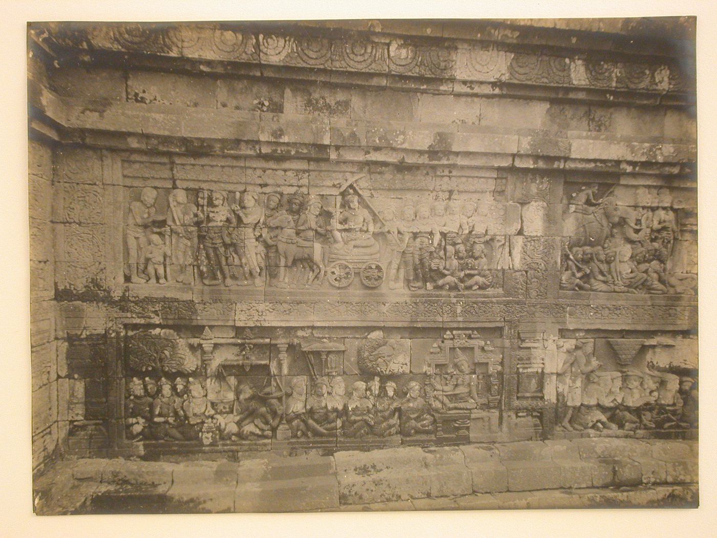 Close-up view of relief panels on the temple of Borobudur depicting a horse drawn chariot, a scale, birds, trees and  figures, Borobudur, Indonesia