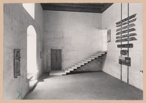 Interior view of Sala VI showing a door, staircase, paintings and reliefs, Palazzo Abatellis, Galleria regionale della Sicilia, Palermo, Italy