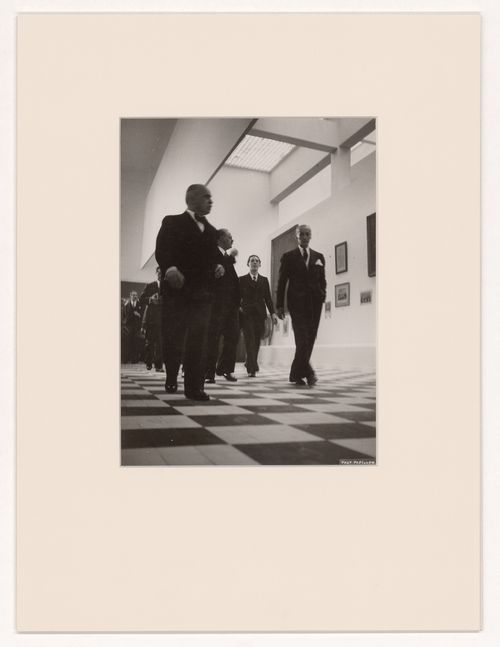 View of Robert Mallet-Stevens guiding visitors in the Solidarité nationale pavillion, Exposition internationale des arts et techniques dans la vie moderne, Paris, France