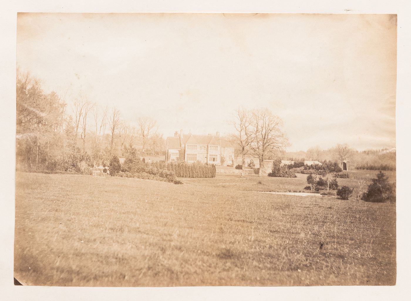 View of dry land, trees and shrubs with a dwelling in the background, Europe[?]