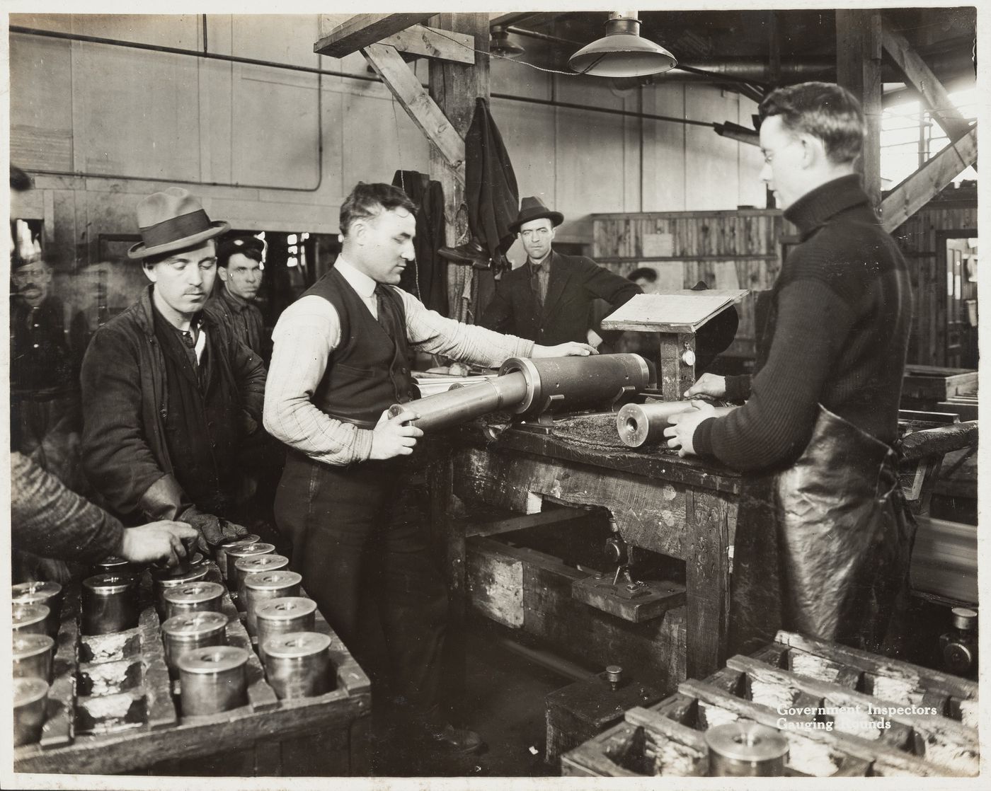 Interior view of inspector gauging rounds at the Energite Explosives Plant No. 3, the Shell Loading Plant, Renfrew, Ontario, Canada