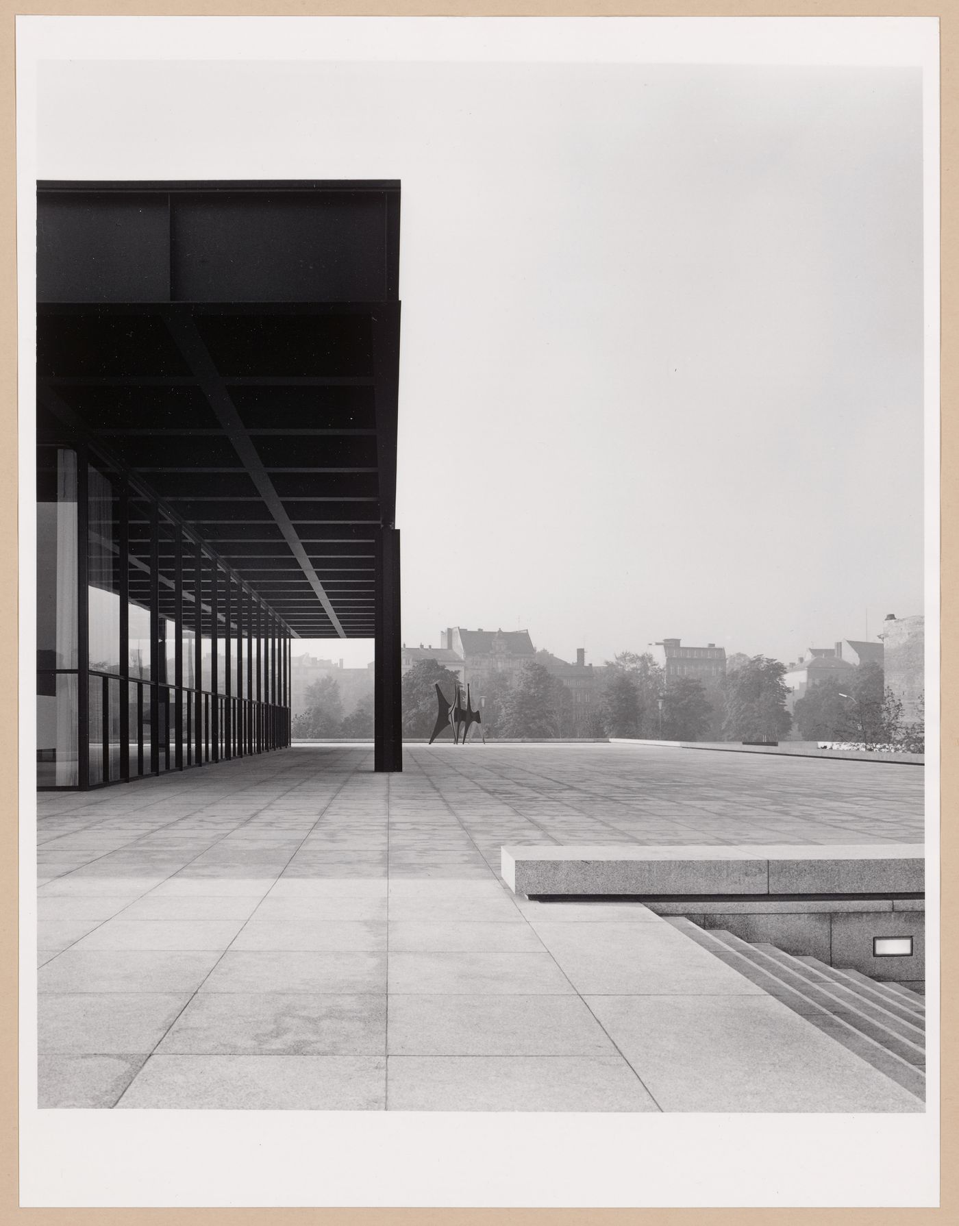 Partial view of a façade of the Exhibition Pavilion showing a square and the sculpture "Tetes et Queue" [Heads and Tails], New National Gallery, Berlin, Germany