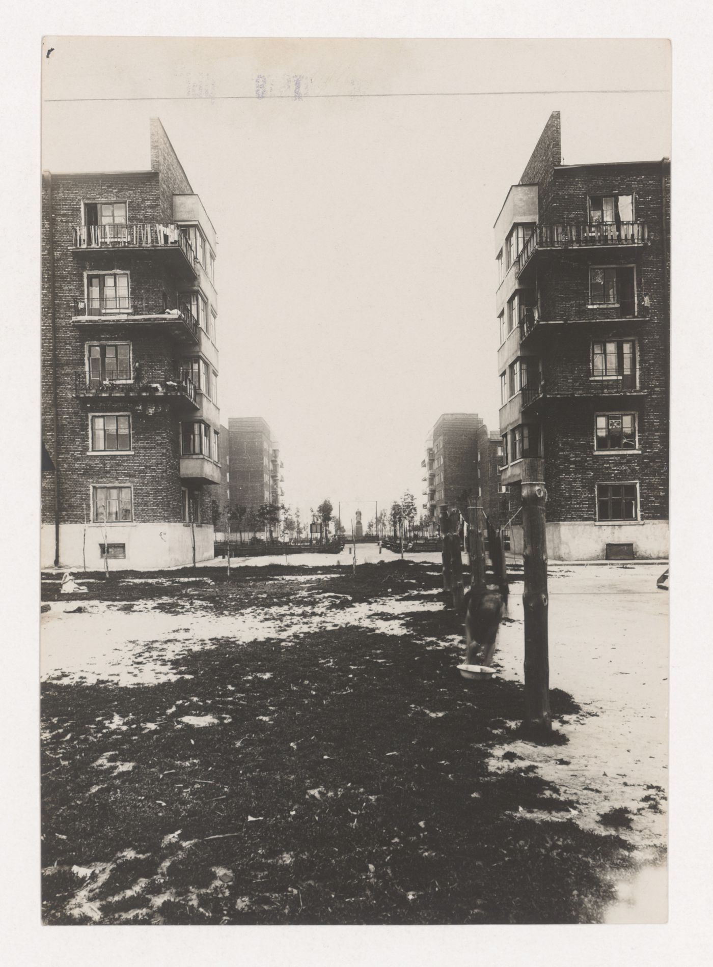 View of a courtyard in the Dangauerovka complex showing housing and a monument in the background, Moscow