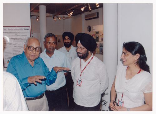 Photograph of Aditya Prakash next to four unidentified people at exhibition at Chitkara University