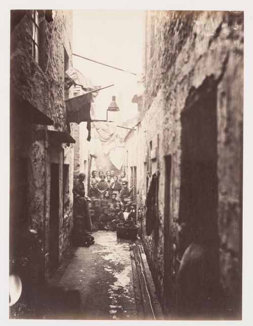 View of Close No. 118 showing a group of residents, High Street, Glasgow, Scotland