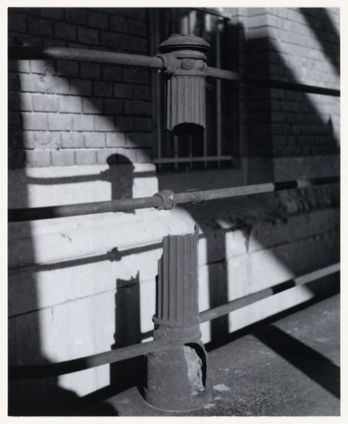 View of a broken metal fence, a wall of brick and stone, a window and cast shadows, Berlin, Germany, from the artist book "The Potsdamer Project"