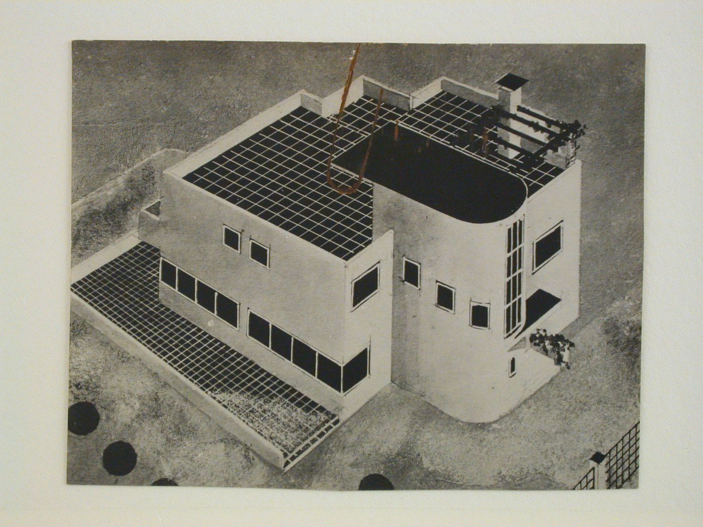 View of a painted drawing showing a house with a tiled terrace on the roof and yard