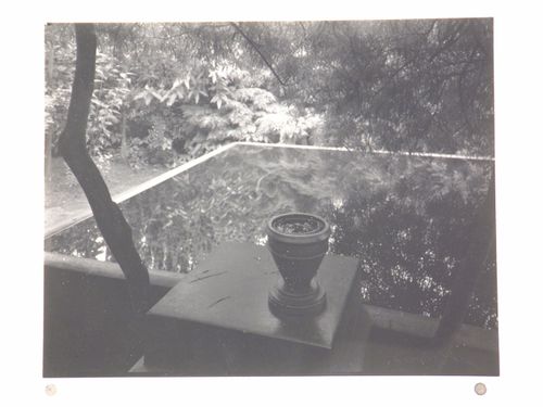 View of architect Otto Rothmayer's own garden showing urn next to water-filled basin reflecting surrounding foliage, Prague, Czechoslovakia