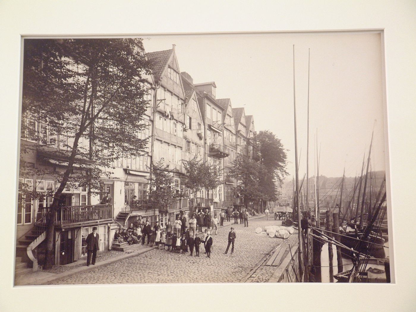 View of quay, wharves, ships, houses and residents, Hamburg, Germany