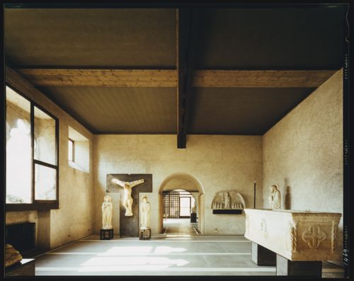 Interior view of a gallery showing statues, reliefs, windows and another gallery, Museo di Castelvecchio, Verona, Italy