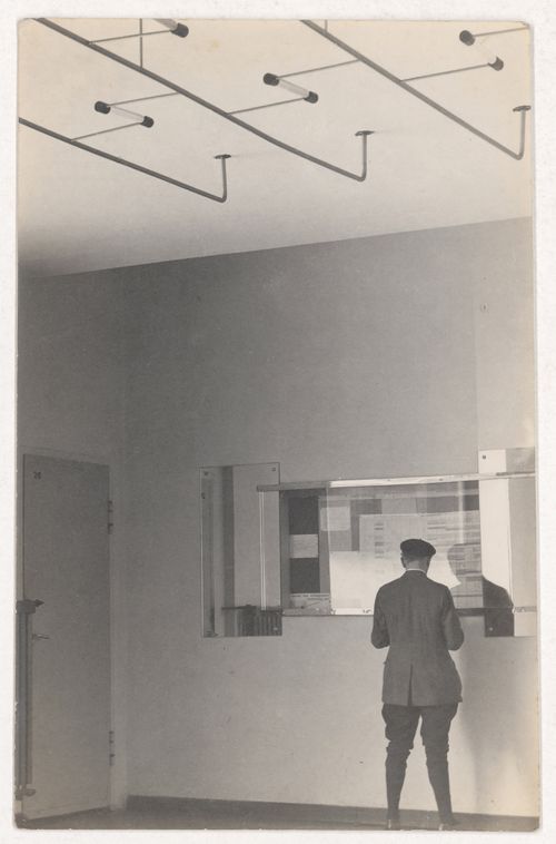 Interior view of Van Nelle Factory showing a man consulting a bulletin board, Rotterdam, Netherlands