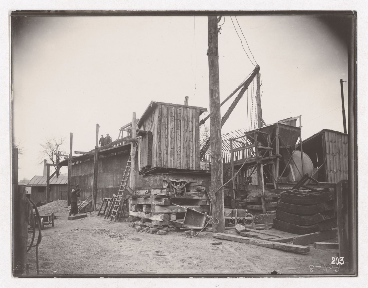 Construction of the Paris Metro, exterior view with wooden buildings and workers, Paris, France