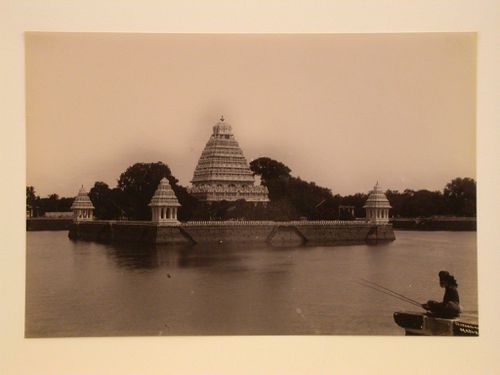 View of three pavilions on the Vandiyur Teppakulam (also known as Vandiyur Mariamman Teppakulam) water tank, and the Meenakshi Temple in the background, Madura (now Madurai), India