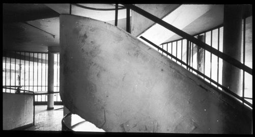 Interior view of the entrance hall showing the spiral staircase with the ramp and pilotis in the background, Villa Savoye, Poissy, France