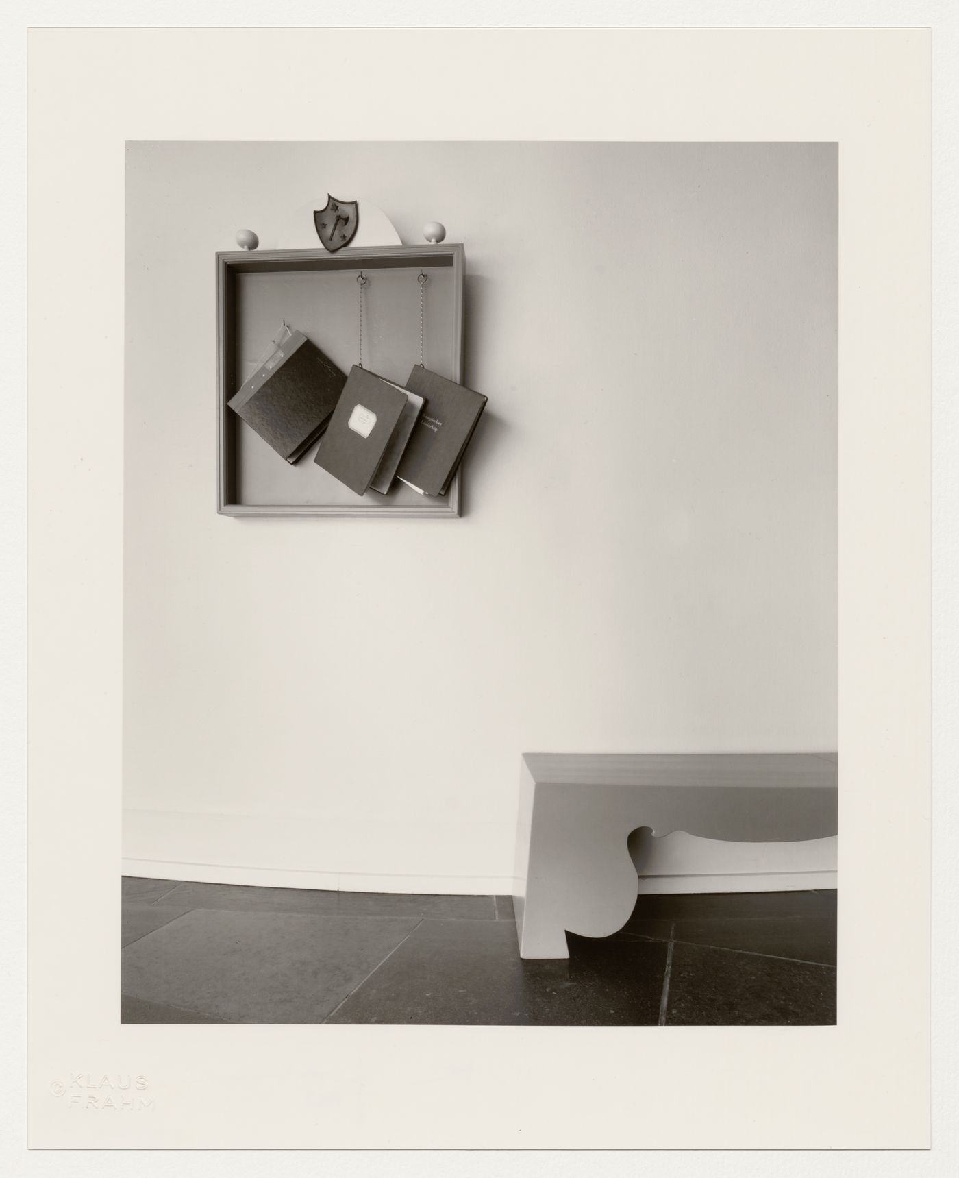 Interior view of binders hanging from a wall cabinet and a bench in the entrance hall of Lister County Courthouse, Sölvesborg, Sweden