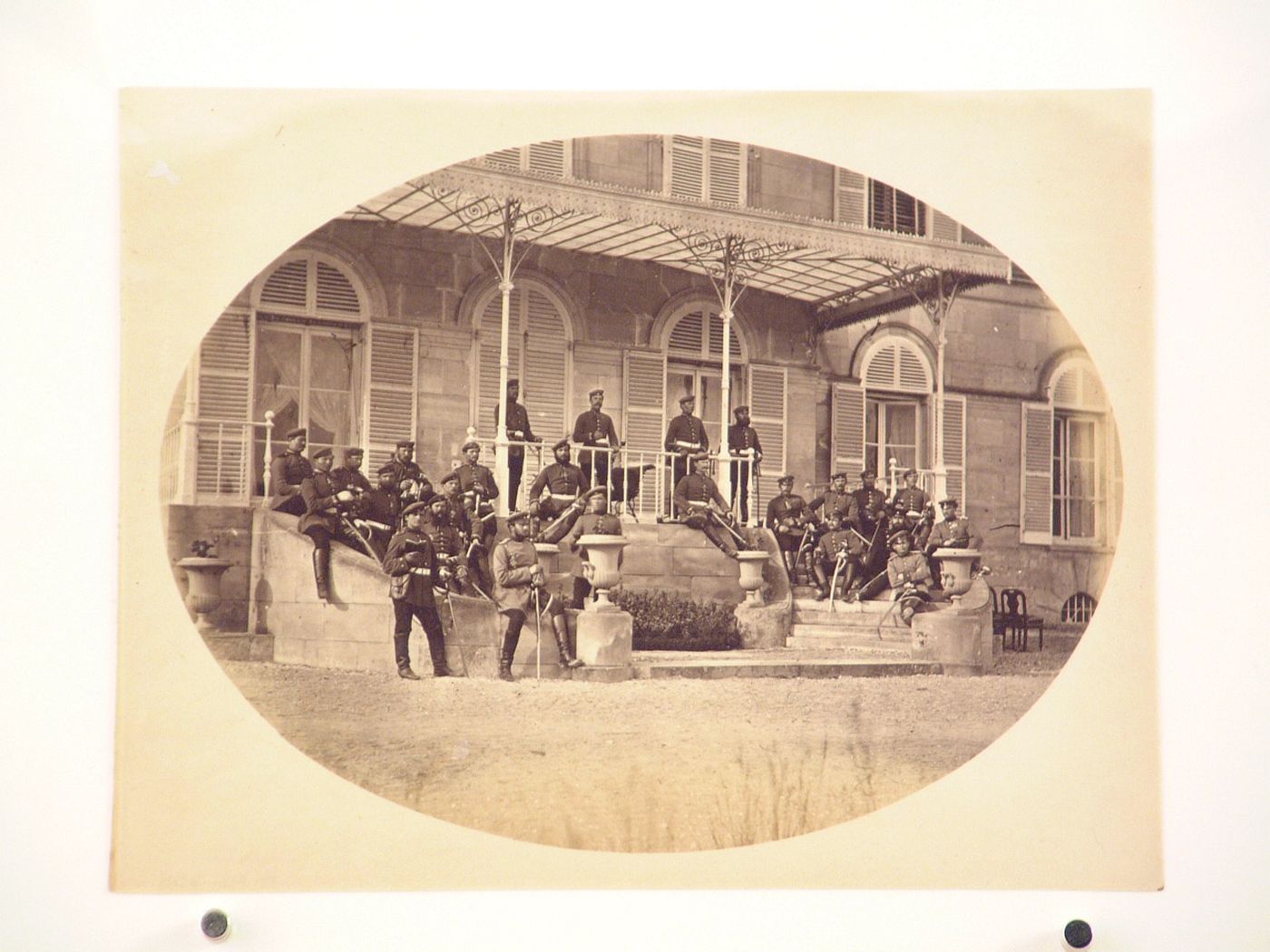 View of Prussian [?] soldiers sitting on the steps of Château Fitzjames [?], near Paris [?], France