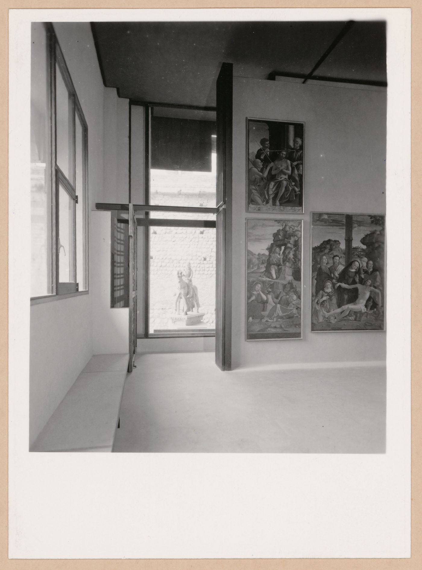 Interior view of a gallery showing paintings with the Can Grande della Scala Statue in the background, Museo di Castelvecchio, Verona, Italy