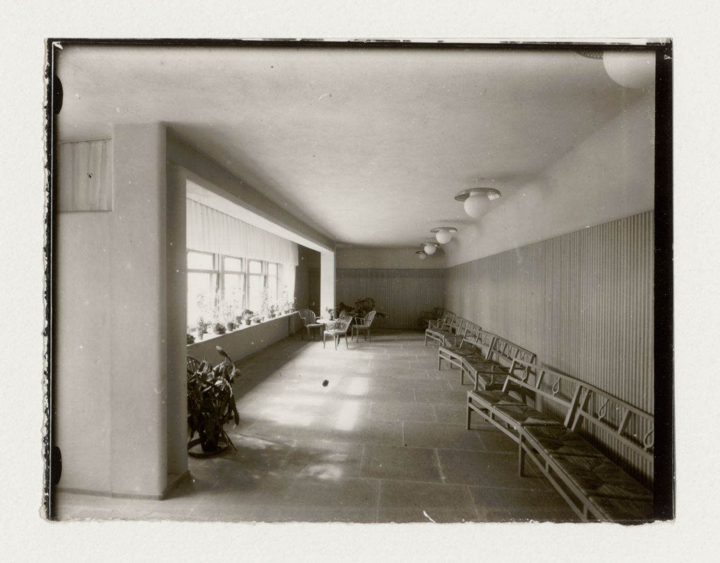 Interior view of the waiting room of the Chapel of the Holy Cross showing settles, a table and chairs, Woodland Crematorium and Cemetery, Stockholm