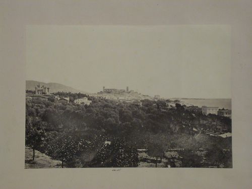 Distant view of a city on a bay showing a château, church [?] and other buildings, France [?]