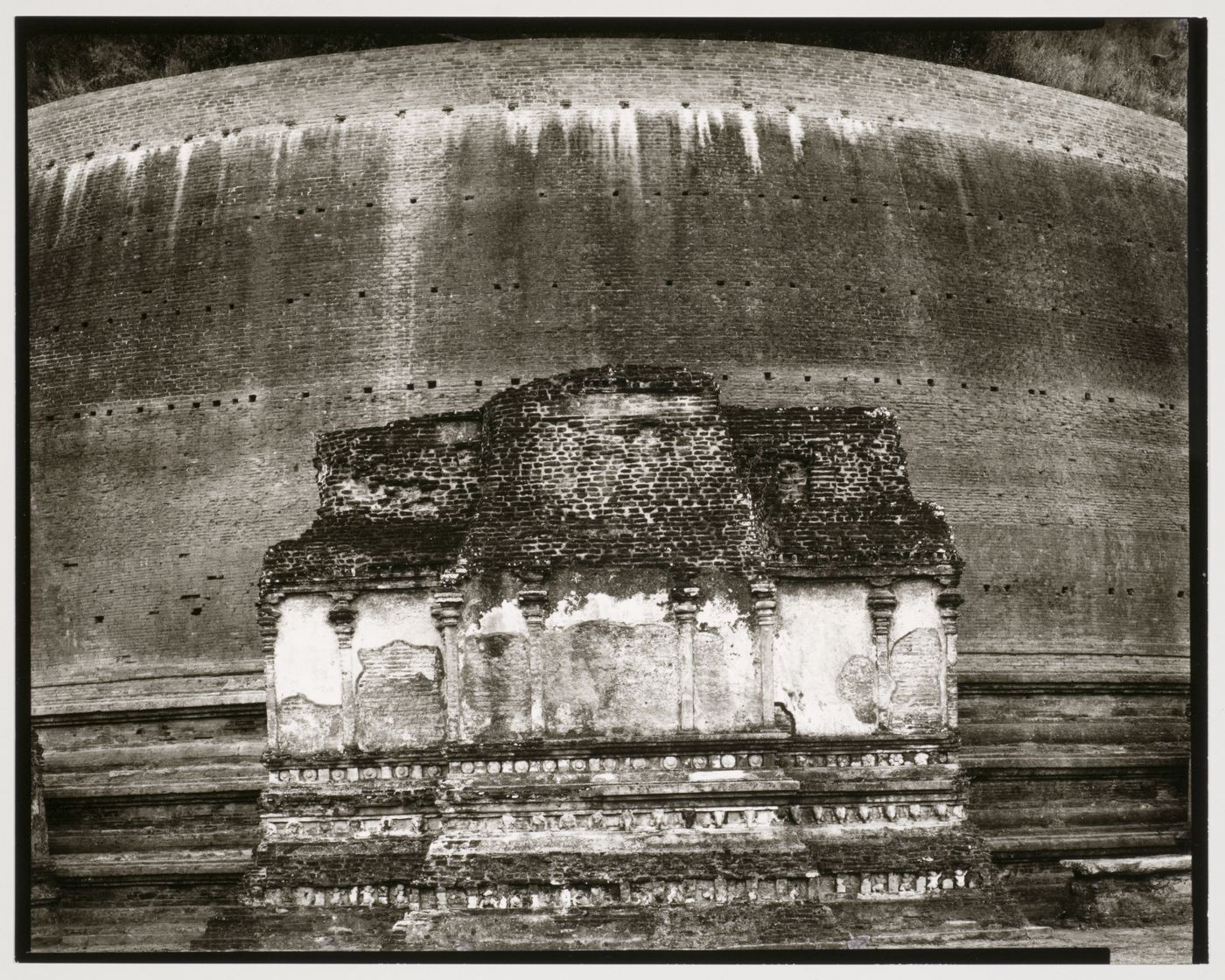 View of a façade of a dagoba with a brick wall in the background, Sri Lanka