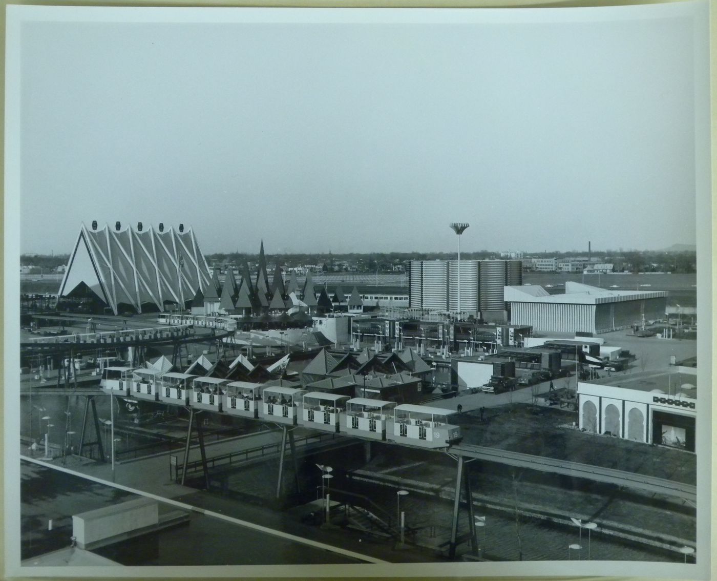 View of the Canadian Pacific-Cominco, Canadian Pulp and Paper, and Steel Pavilions with the minirail in foreground, Expo 67, Montréal, Québec