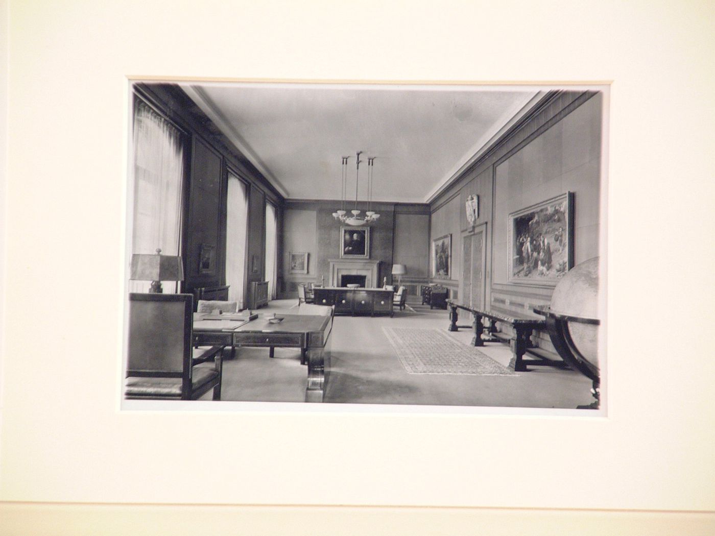 Interior, imposing room with desk, paintings, and large globe, Munich, Germany