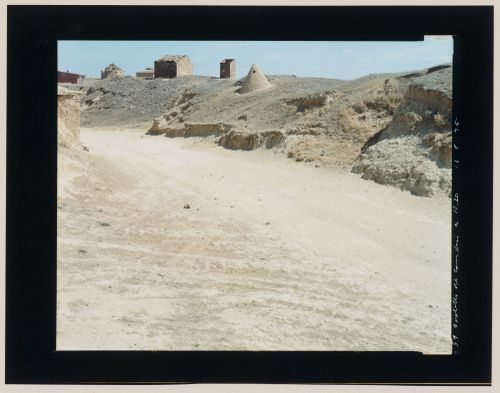 View of a dirt road, pigeon lofts and brick structures and an adobe vent probably connected to an underground wine cellar, Boadilla del Camino, Palencia Province, Spain (from the series "In between cities")
