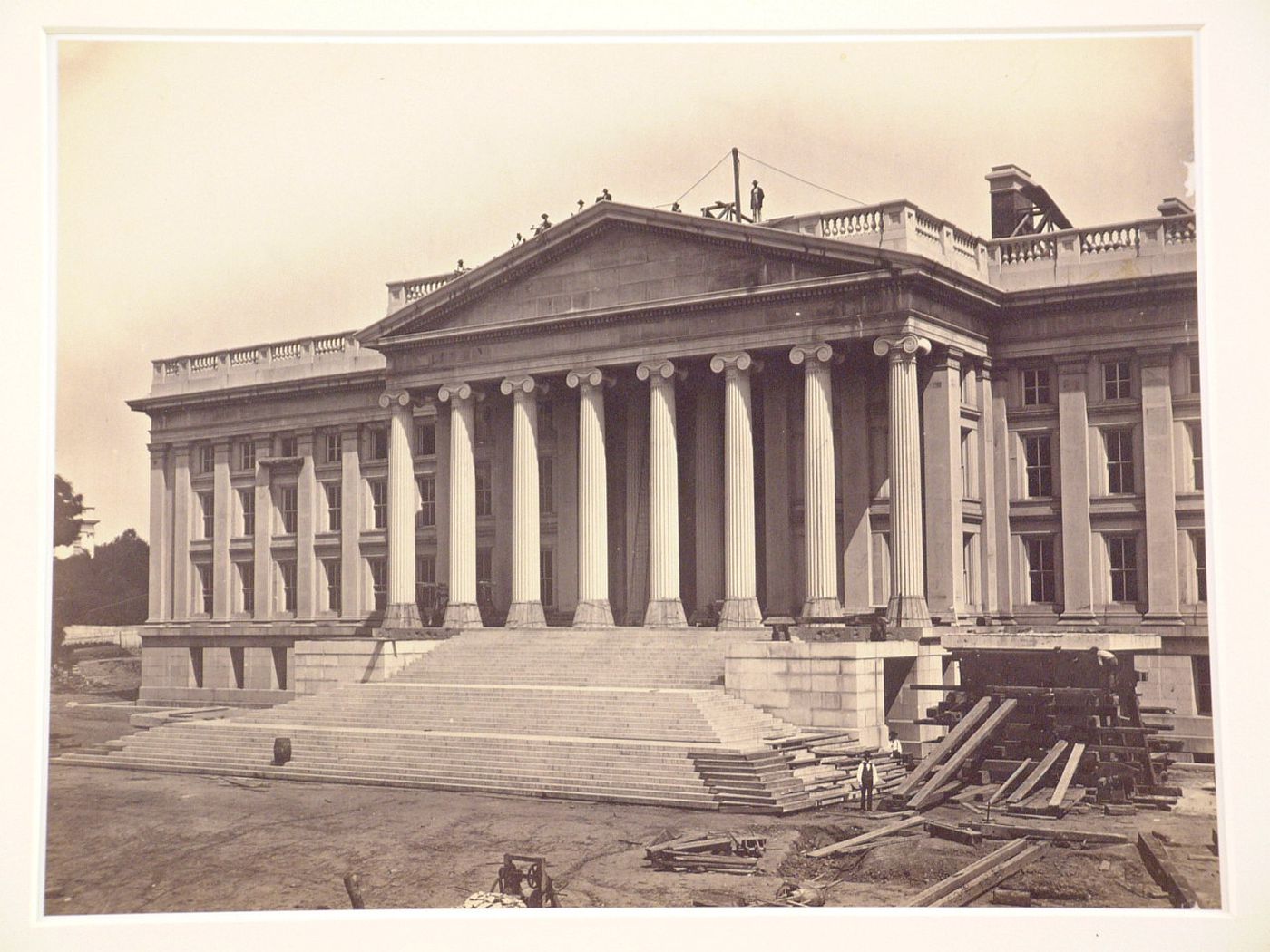 Treasury Building under contruction: Workmen on roof and on ground level, right side, Washington, District of Columbia