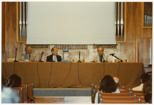 Photograph of Pettena and two colleagues giving presentation or press conference for exhibition Olmsted: L'origine del parco urbano e del parco naturale contemporaneo