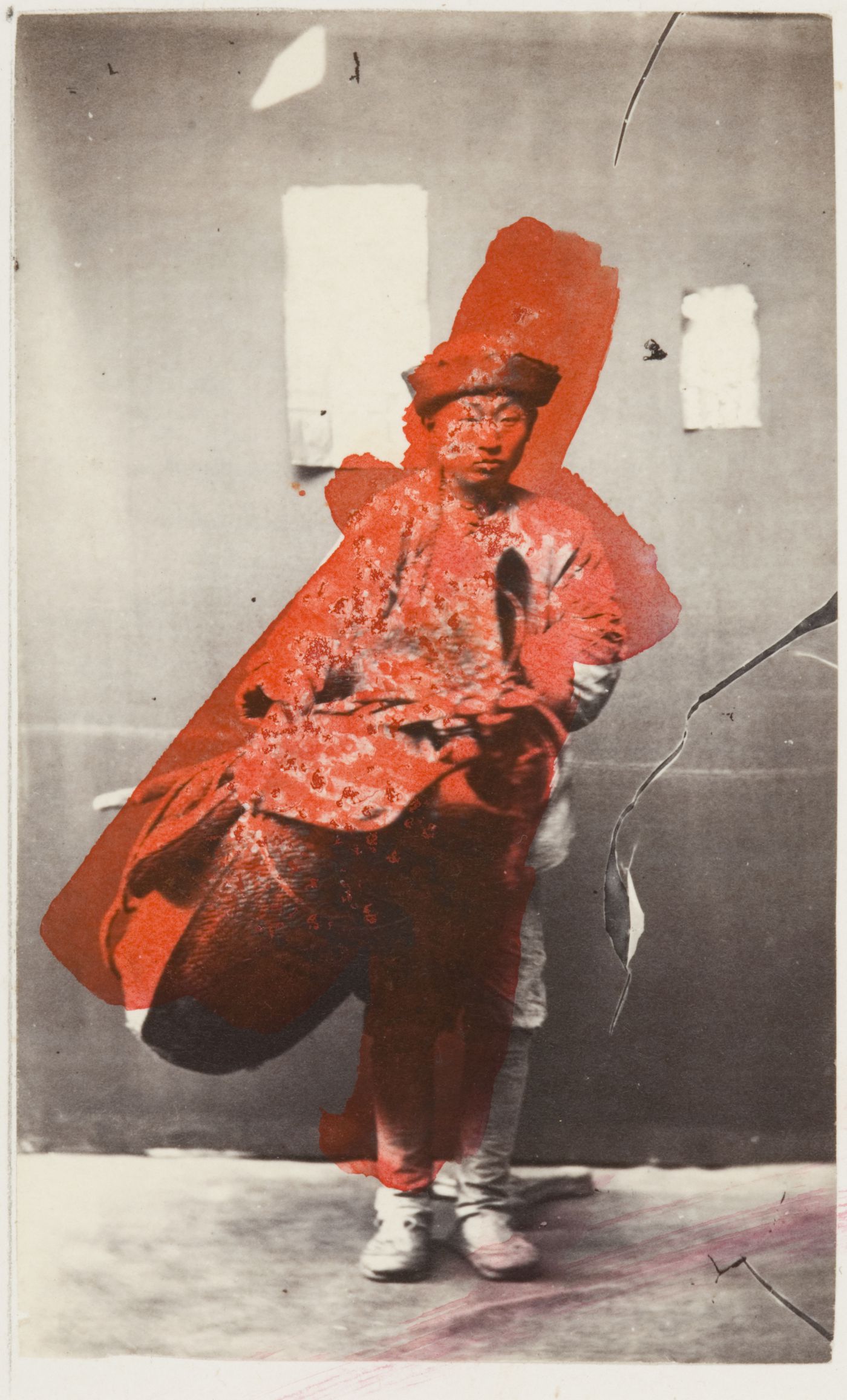Portrait of a Chinese cobbler (peddler) standing with his equipment