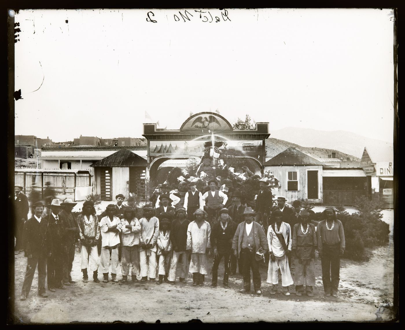 View of a group of Indigenous people and several men in European-American clothing at a gathering, United States of America