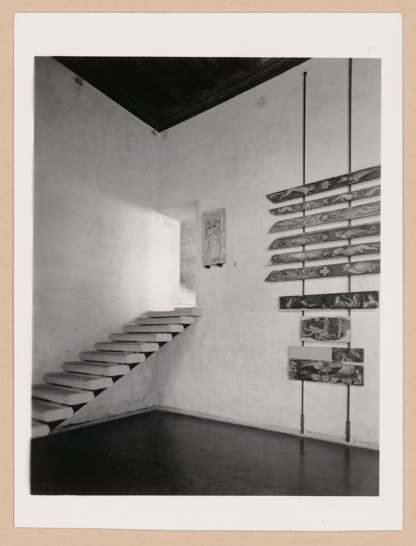 Interior view of Sala VI showing a staircase, paintings and a relief, Palazzo Abatellis, Galleria regionale della Sicilia, Palermo, Italy