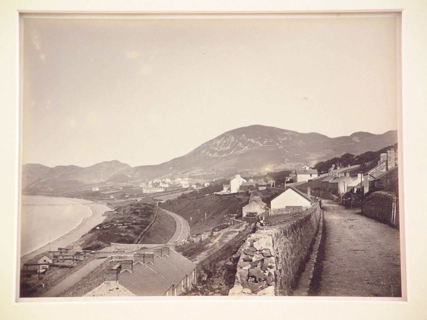 Distant view of town, hills, and shore, Penmaenmawr, Wales