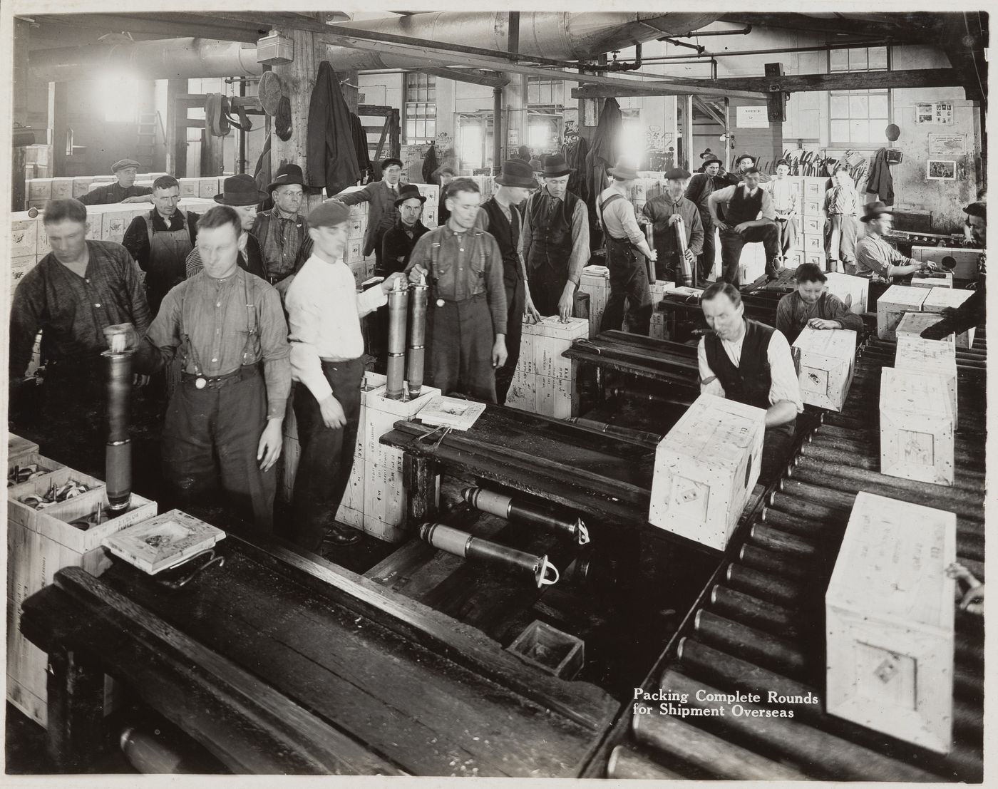 Interior view of workers packing complete rounds for shipment at the Energite Explosives Plant No. 3, the Shell Loading Plant, Renfrew, Ontario, Canada