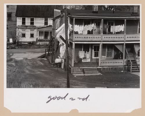 View of the rear façade of a house showing clothes hung on a clothes line with another house in the background, New Jersey