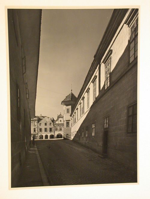 View looking up a street towards the Námestí Míru [Town Square] showing a wing (now the Art Gallery Jana Zrzavého) of Telc Château on the right, Telc, Czechoslovakia (now Czech Republic)