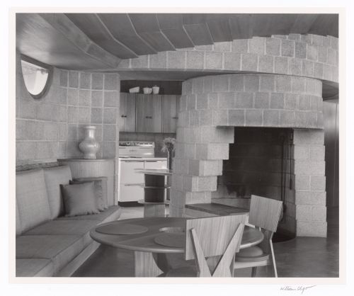 Living room and fireplace with kitchen beyond, from the series The David and Gladys Wright House
