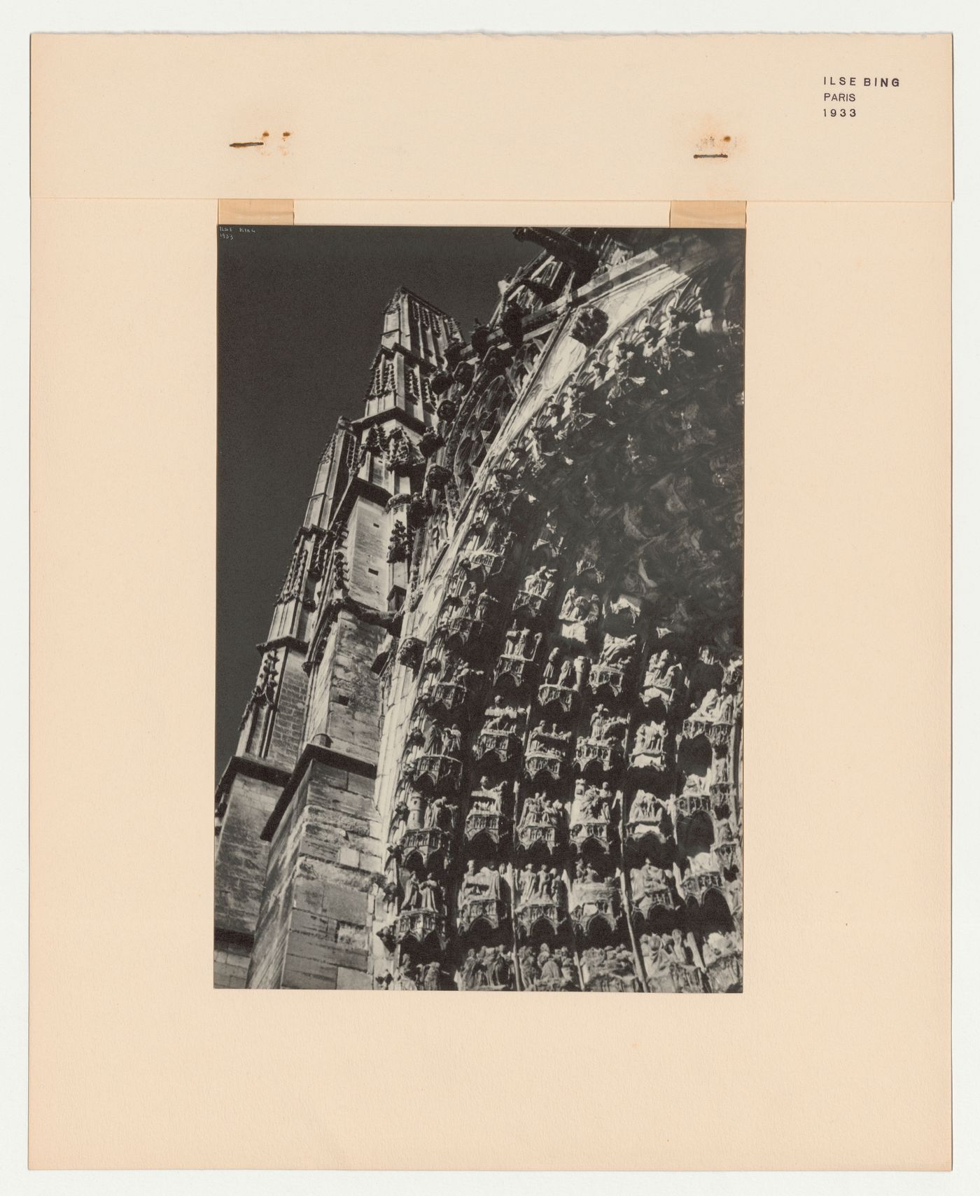 Partial view of a cathedral showing a tower and carvings, France