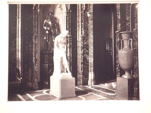 View of interior of Eaton Hall with statue, armor, and stone vase, Chester, England