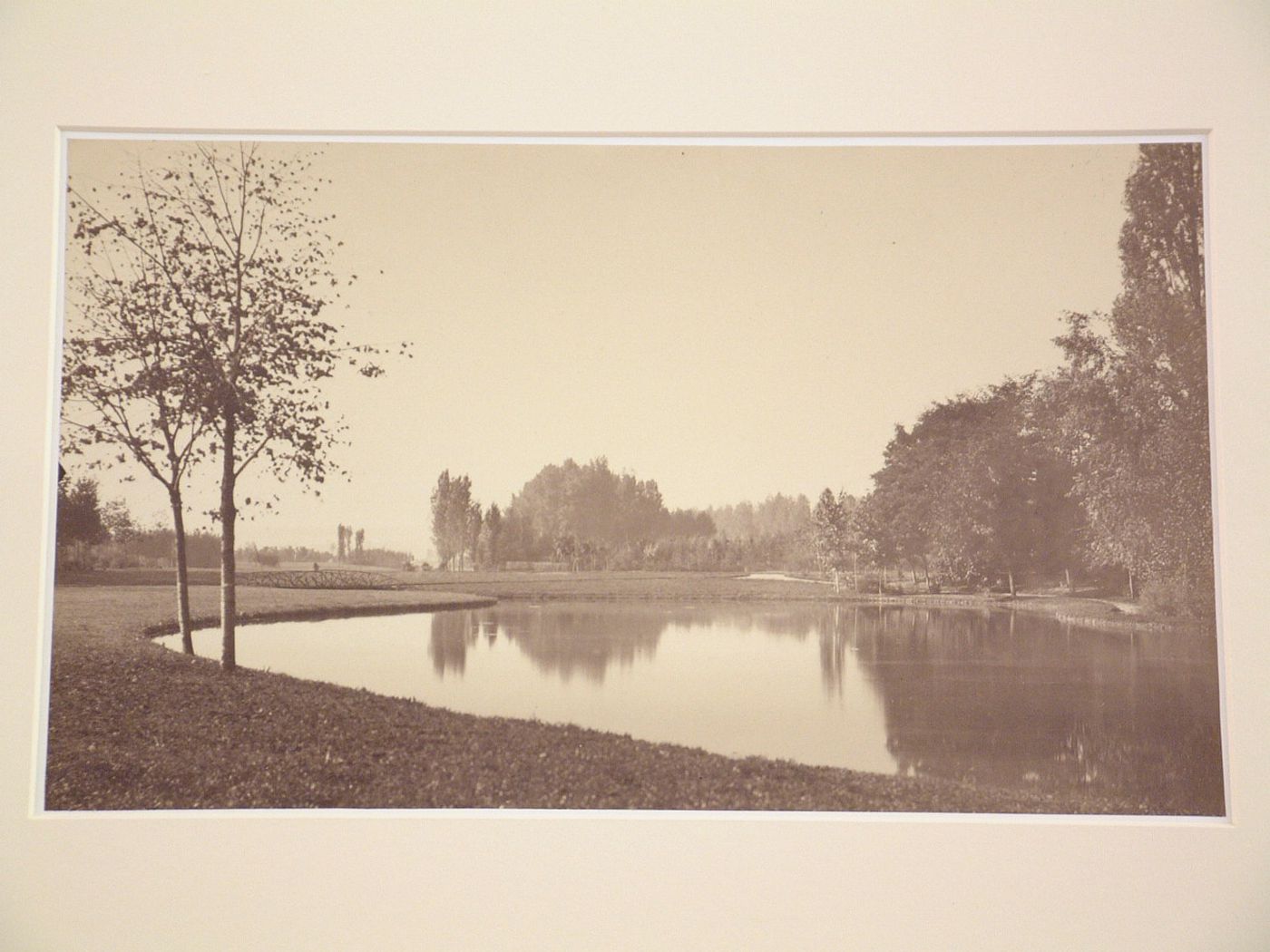 View of a lake, with two small trees at left, Bois de Boulogne, Paris, France